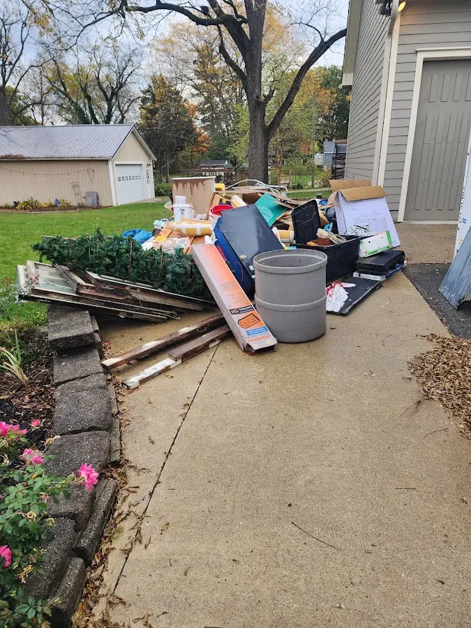 Dumpster being loaded with debris for Roofing Dumpster Rental in New Lenox
